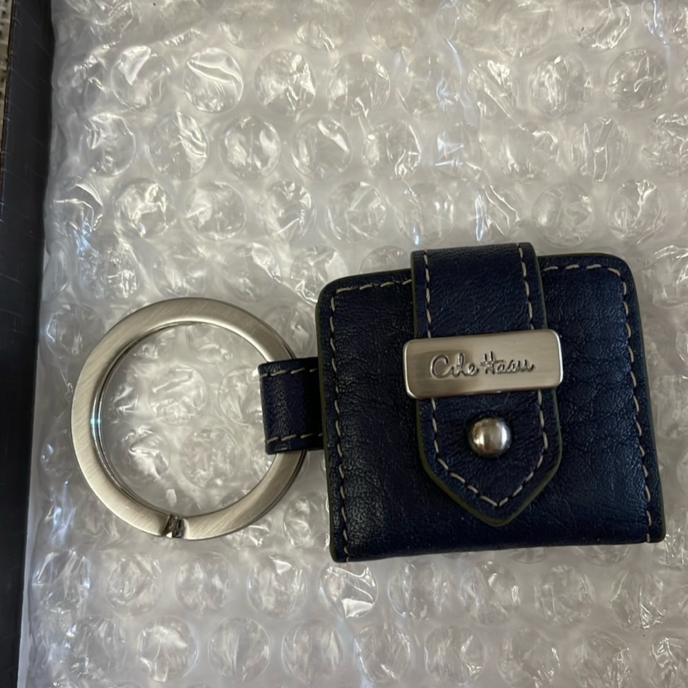 Cole Haan Keychain 
made of leather, with two pockets for photo.